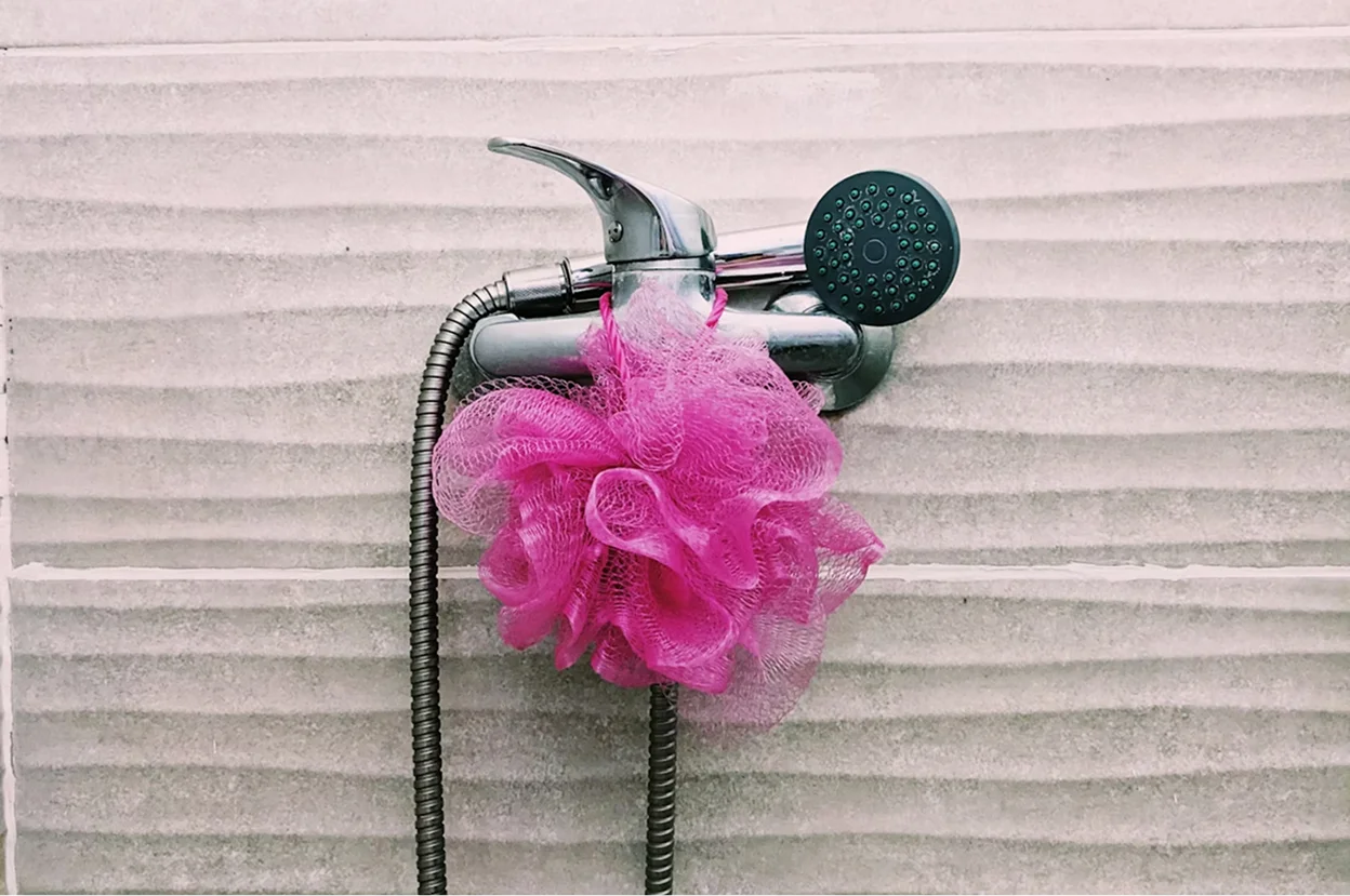 a pink flower in a black basket