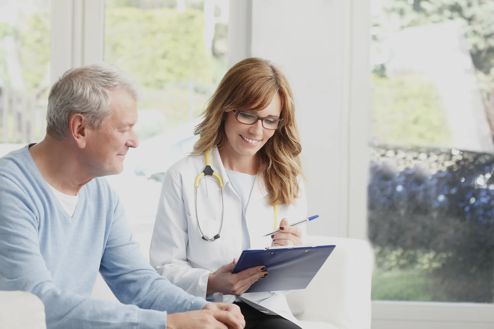 a doctor and a man looking at a tablet